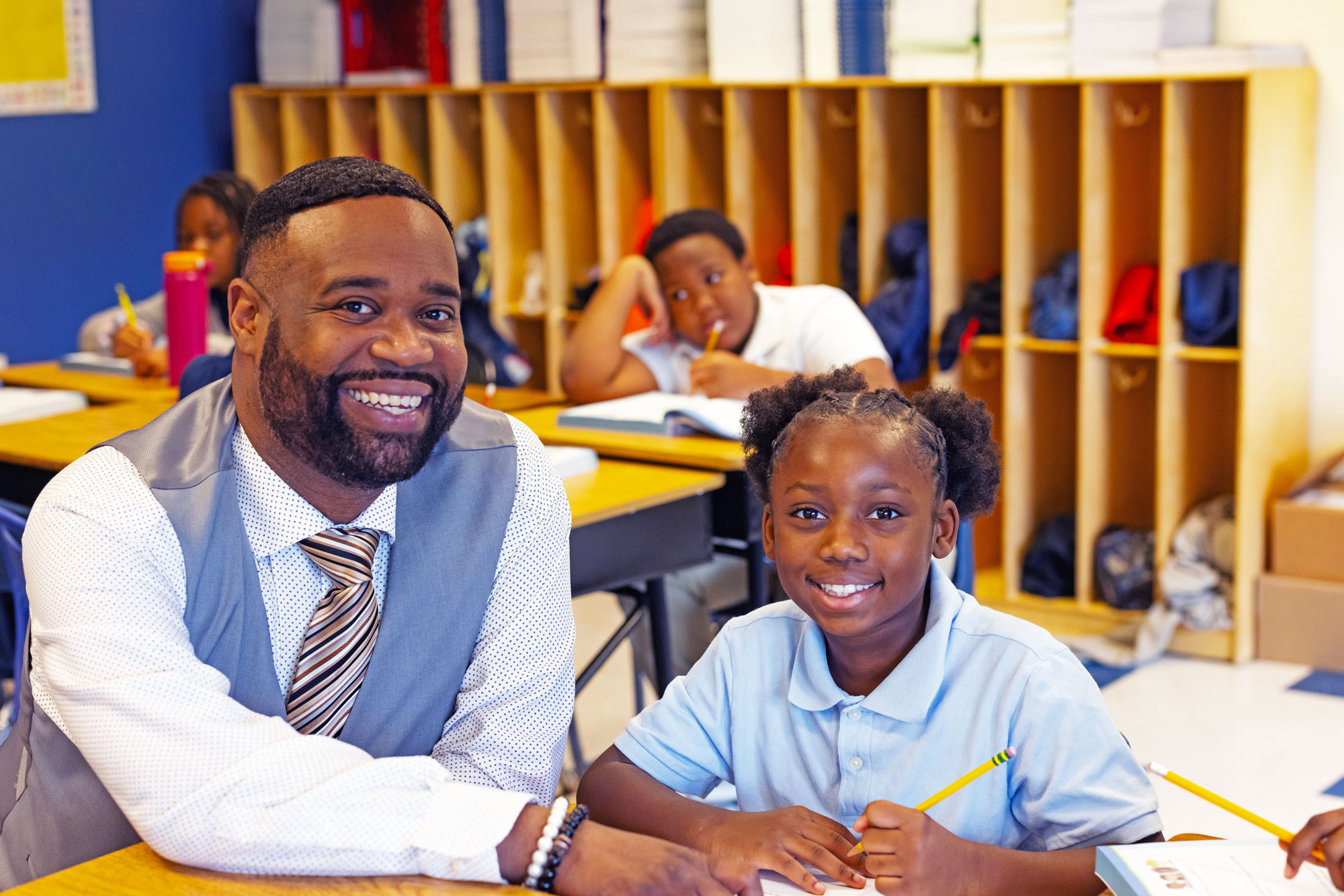A teacher and student smiling in the classroom